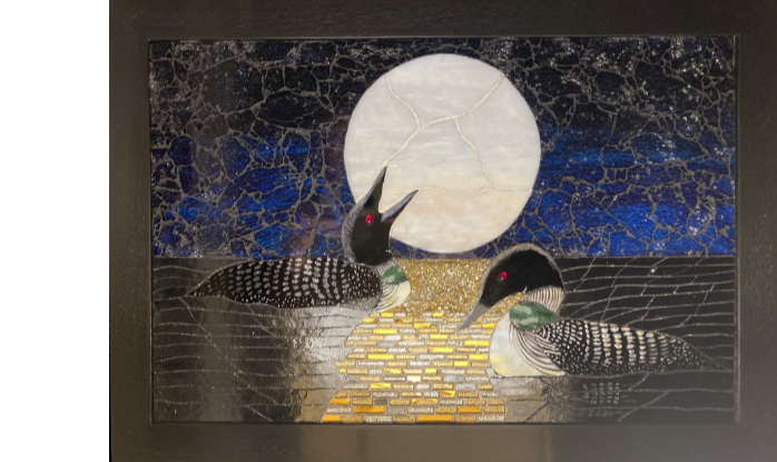 Two loons at night in bright moonlight